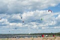 Kiters on the bay on a sunny windy day. People at the beach. Summer sport. Summer lifestyle.