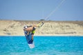 Kiteboarder performing kiteboarding jumps and tricks