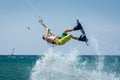 Kitesurfer jumping, kite-boarder performing kiteboarding jump