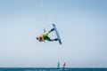 Kitesurfer jumping, kite-boarder performing kiteboarding jump