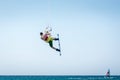 Kitesurfer jumping, kite-boarder performing kiteboarding jump