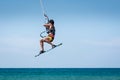 Kitesurfer jumping, kite-boarder performing kiteboarding jump