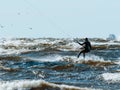 Kitesurfer rides the waves in a wetsuit Royalty Free Stock Photo