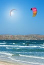 Kitesurfer riding in the waves in the sea