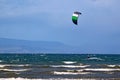 Kitesurfer riding in waves