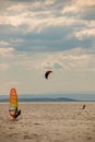 Kitesurfer vs. windsurfer at the ocean