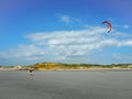 Kitesurfer walking back to the beach at Pointe aux oies, France