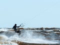 Kitesurfer in a wetsuit flying over the wave Royalty Free Stock Photo