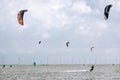 Kitesurfers, in the background windmills