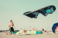 Kitesurfers on the beach prepare sport equipment Royalty Free Stock Photo