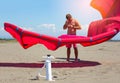 Kitesurfers on the beach prepare sport equipment for riding