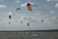 Kitesurfers on the lake ride on crest of a wave Royalty Free Stock Photo