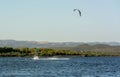 Kitesurfers riding near Punta Trettu, near Cagliari, in Sardinia, Italy, at Golden hour on Blurred Coastline background