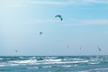 Kitesurfers riding in the waves