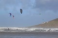 Kitesurfers riding waves