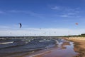 Kitesurfers on the shore of the Gulf of Finland on a windy summer day. Active sports in the vicinity of St. Petersburg