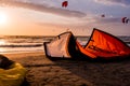 Kitesurfing beach, kiteboarding sport, kites n the beach and in the air at sunset, golden our landscape of Kite location, February