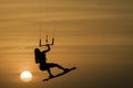 Kitesurfing girl silhouette jumping at golden hour sunset woman kiteboarding jump Royalty Free Stock Photo