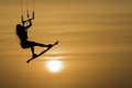 Kitesurfing girl silhouette jumping at golden hour sunset woman kiteboarding jump Royalty Free Stock Photo