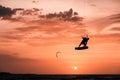 Kitesurfing jump, Man kitesurfer athlete jumping at sunset, silhouette at dusk man doing board greab