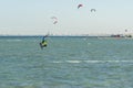 Kitesurfing Kiteboarding action photos man among waves quickly goes. A kite surfer rides the waves. lens illumination. toned