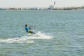 Kitesurfing Kiteboarding action photos man among waves quickly goes. A kite surfer rides the waves. lens illumination. toned