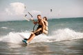 Kitesurfing. Man Rides On Kite On Waves With Girl