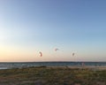 Kitesurfing in the summer near coast on the sunset