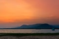 Kitesurfing at the sunset with mountain view