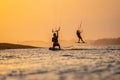 kitesurfing. A surfer rides on a beautiful backdrop of bridges and coastline at sunset and performs all kinds of stunts