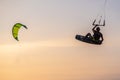 kitesurfing. A surfer rides on a beautiful backdrop of bridges and coastline at sunset and performs all kinds of stunts