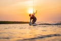 kitesurfing. A surfer rides on a beautiful backdrop of bridges and coastline at sunset and performs all kinds of stunts
