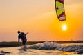 kitesurfing. A surfer rides on a beautiful backdrop of bridges and coastline at sunset and performs all kinds of stunts