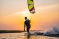 kitesurfing. A surfer rides on a beautiful backdrop of bridges and coastline at sunset and performs all kinds of stunts