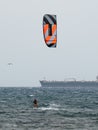 Kitesurfing During a Windy Day with a Very Rough Sea and Industrial Boat in the background Royalty Free Stock Photo