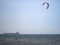 Kitesurfing During a Windy Day with a Very Rough Sea and Industrial Boat in the background Royalty Free Stock Photo