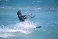 Kitesurfing. The young man is flying on the sea wave on the Board.