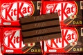 KitKat dark a chocolate wafer bar close-up view opened on Kit Kat background in their packaging
