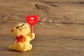 A kitten figurine holding a red heart