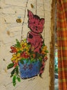 Kitten in flower basket painting on white brick wall