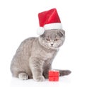 Kitten in red santa hat with gift box. isolated on white Royalty Free Stock Photo