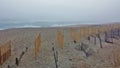 Kitty Hawk Beach Barrier Fence in Fog Royalty Free Stock Photo