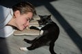 Kitty rest. Cat lies near woman. The fluffy black cat comfortably settled to sleep or to play. Cute cozy morning place Royalty Free Stock Photo