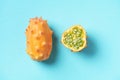 Kiwano or african horned melon on blue background. Top view. Cutted hedged gourd, african horned cucumber, english tomato. Exotic