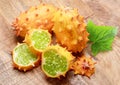 Kiwano fruit with kiwano slices on wooden background. Top view Royalty Free Stock Photo