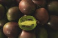 Kiwi Berries, with one cut open to show seeds