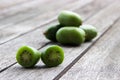 Kiwi berries (arctic kiwifruit) on wooden table