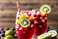 Kiwi berry lemonade in a glass with a background of fresh kiwi slices and assorted berries. AI generated. Royalty Free Stock Photo