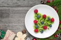 Kiwi christmas tree with fir tree branches and gift boxes over rustic wooden table. funny food idea for kids Royalty Free Stock Photo