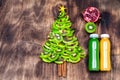 Kiwi Christmas tree - fun food idea for kids party or breakfast, New Year food on wooden background. Christmas tree food concept. Royalty Free Stock Photo